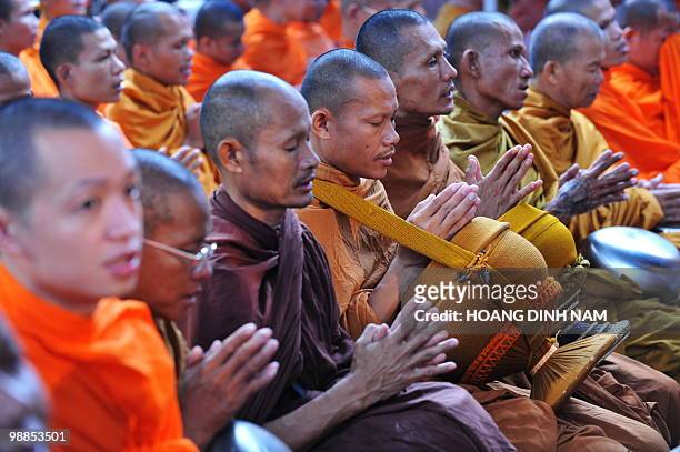 Thai Buddhist monks join "Red Shirt" anti-government protester in prayer during a ceremony to mark the 60th Coronation Day for King Bhumibol...