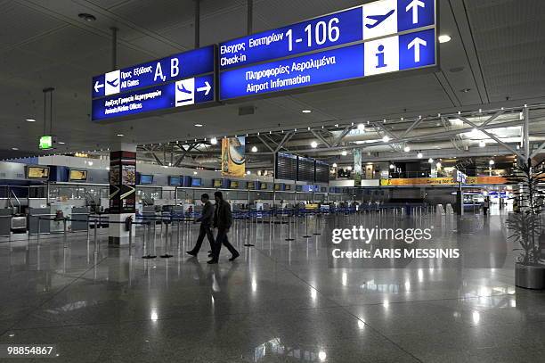 People walk at the empty departure hall of the Athens International airport during a 24 hours general strike on May 5, 2010. A nationwide general...