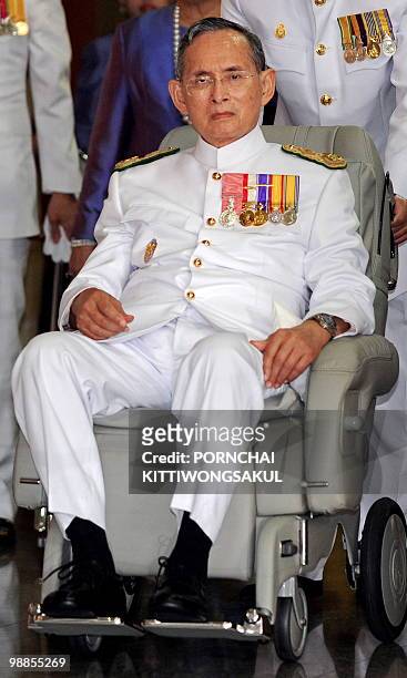 Thai King Bhumibol Adulyadej sits in a wheelchair as he marks the 60th anniversary of his coronation in Bangkok on May 5, 2010. The 82-year-old...
