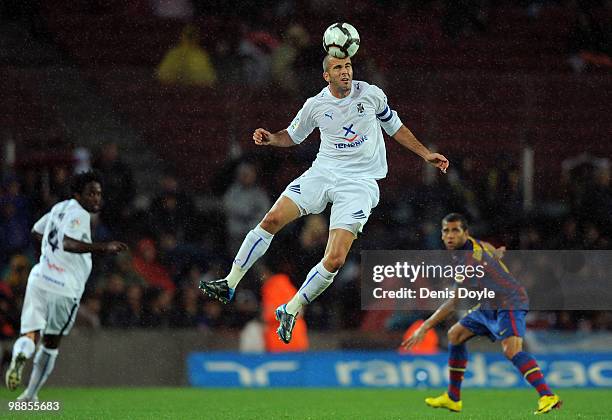 Manuel Martinez of Tenerife heads the ball under the gaze of Daniel Alves during the La Liga match between Barcelona and Tenerife at Camp Nou stadium...