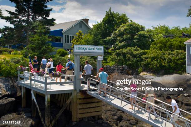 tourists disembark the ferry bennie alice to cabbage island in linekin bay, boothbay harbor maine - boothbay harbor stock pictures, royalty-free photos & images