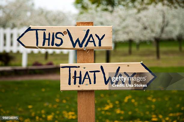 way sign "this way, that way" - lisa stokes stock pictures, royalty-free photos & images