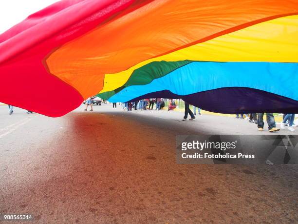 Giant gay flag waving on the street when thousands of activists from the LGBT community and sympathizers take to the street to participate in the...