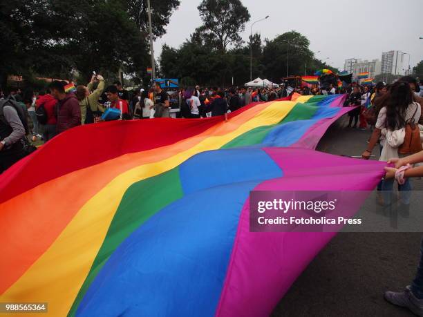 Giant gay flag waving on the street when thousands of activists from the LGBT community and sympathizers take to the street to participate in the...