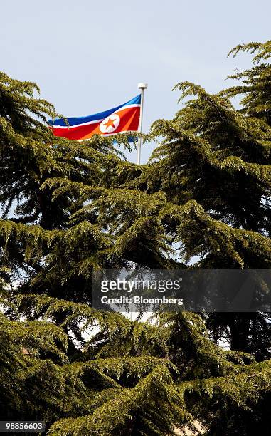 The North Korean flag flies over the country's embassy in Beijing, China, on Wednesday, May 5, 2010. A motorcade of about 40 cars arrived at...