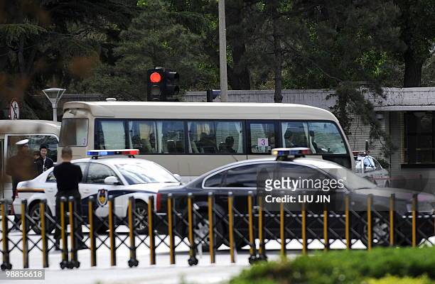 Van carrying officials drives with a diplomatic motorcade entering Diaoyutai State Guest House in Beijing on May 5, 2010. North Korea's leader Kim...