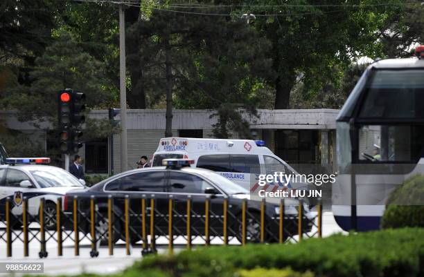 An ambulance drives with a diplomatic motorcade entering Diaoyutai State Guest House in Beijing on May 5, 2010. North Korea's leader Kim Jong-Il was...