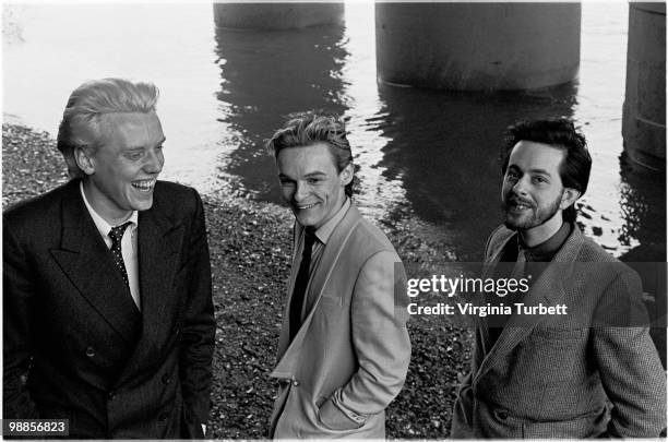 Glenn Gregory, Ian Craig Marsh and Martyn Ware of Heaven 17 pose for a group portrait session by the Thames at Embankment on March 31st 1981 in...