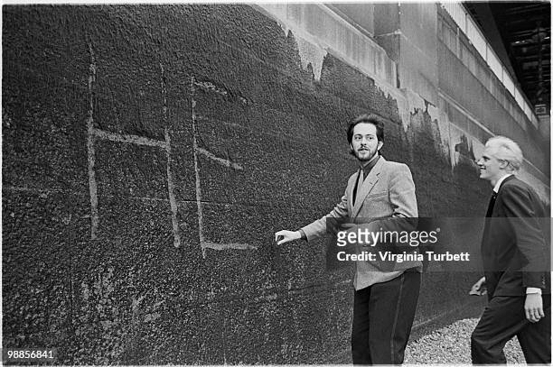 Martyn Ware and Glenn Gregory of Heaven 17 scratch the band name into the wall by the Thames at Embankment on March 31st 1981 in London.