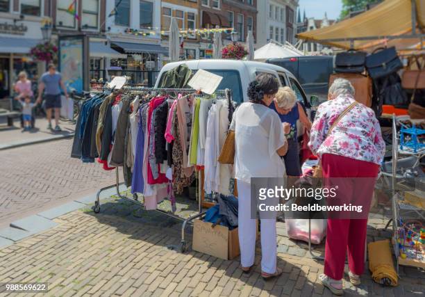 vintage clothing market stall on town square - gouda stock pictures, royalty-free photos & images