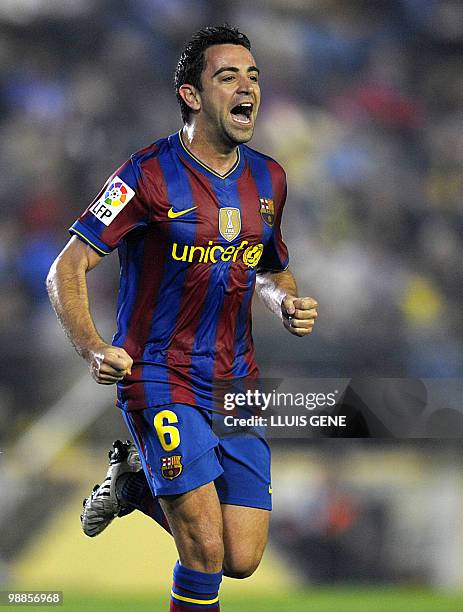 Barcelona's midfielder Xavi Hernandez celebrates after scoring against Villarreal during a Spanish league football match at Madrigal stadium in...