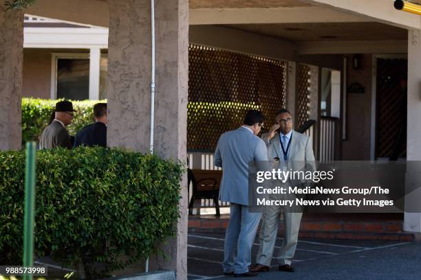San Jose Police Department detectives talk at an apartment complex on June 28, 2018 in San Jose. A primary suspect in the notorious ritualistic...