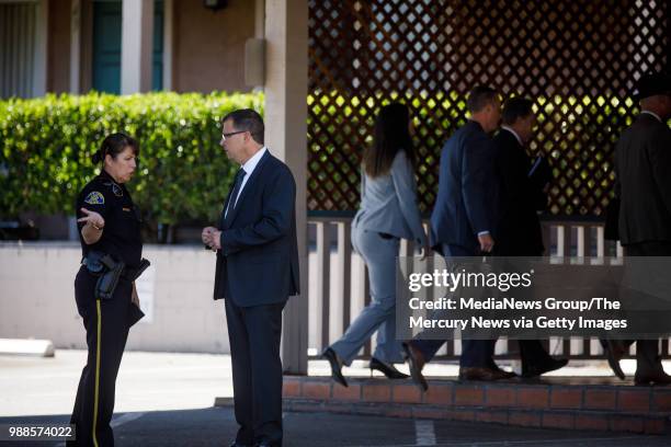 Law enforcement officers talk at an apartment complex on June 28, 2018 in San Jose. A primary suspect in the notorious ritualistic killing of Arlis...