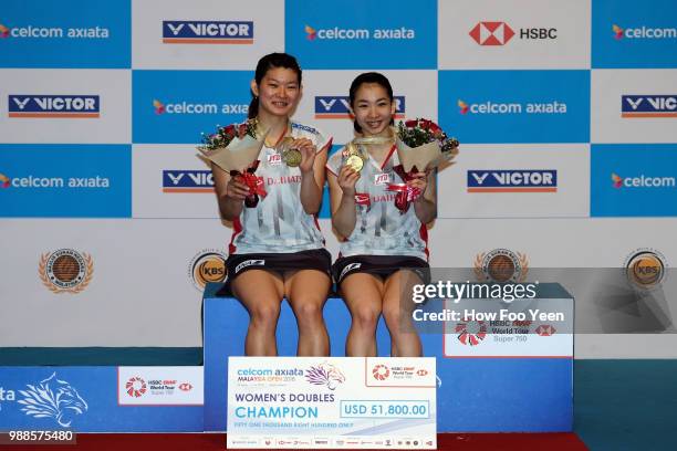 Misaki Matsotomo and Ayaka Takahashi of Japan pose after winning the double final against Chen Qingchen and Jia Yifan of Chinaa during Celcom Axiata...