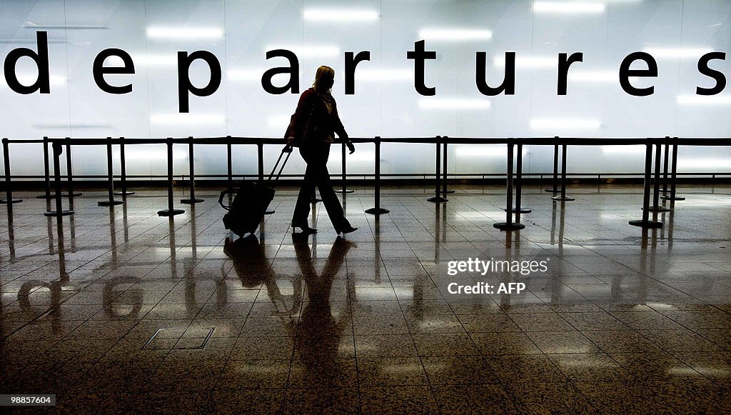 A woman pulls her suitcase as she walks