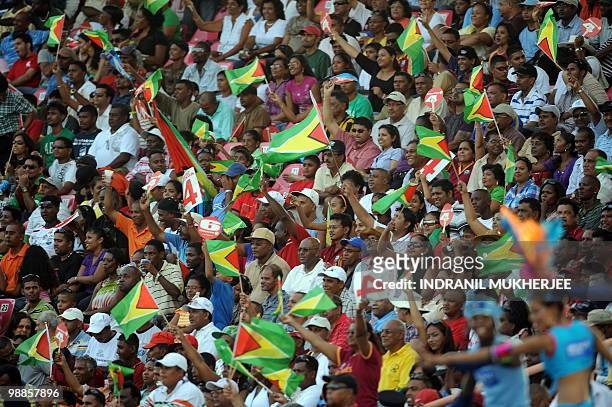 Spectators wave the Guyanese flag as West Indies cricketer Shivnarine Chanderpaul plays a shot against Ireland during their ICC World Twenty20 2010...