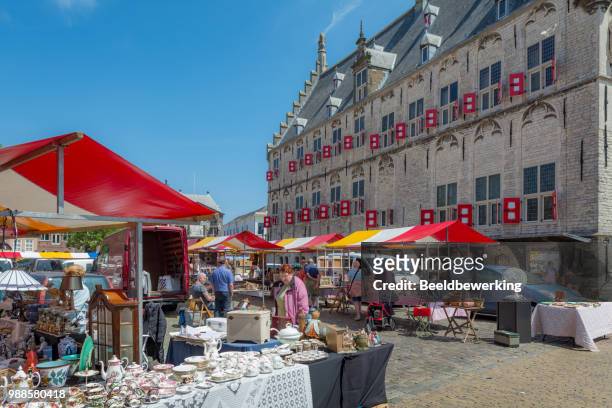 market with lots of china next to famous 15th century town hall - gouda stock pictures, royalty-free photos & images