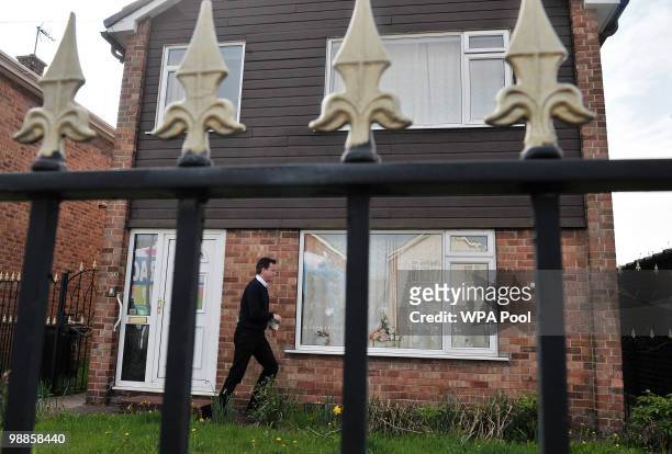 Conservative party Leader David Cameron delivers leaflets as he canvasses potential voters on May 5, 2010 in Hucknall, England. Today is the full...