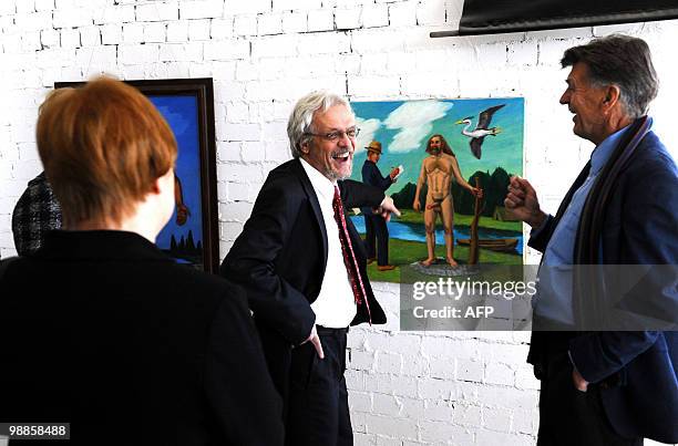 Finnish President Tarja Halonen and her husband Pentti Arajarvi look at exhibits during a visit to a small art gallery owned by Jaan Manitski along...