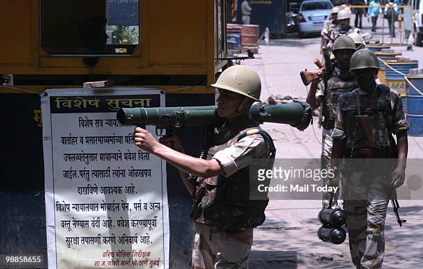 Armed Indian security officers patrol outside the special court set up for the trial of of Mohammad Ajmal Kasab, the lone surviving gunman of the...