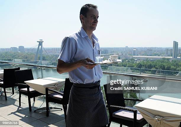 Waiter carries coffee on April 30, 2010 at the Parlamentka restaurant in Bratislava. AFP PHOTO / SAMUEL KUBANI