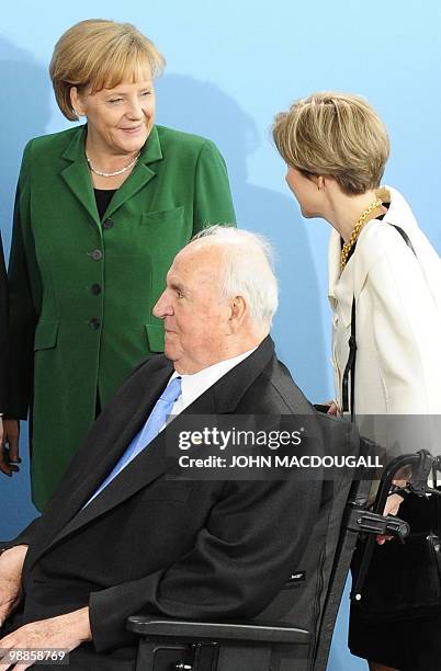 German Chancellor Angela Merkel chats with Meike Kohl-Richter, wife of former German Chancellor Helmut Kohl, as Helmut Kohl looks on during an...