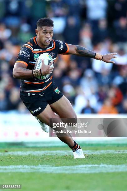 Michael Chee Kam of the Tigers runs with the ball during the round 16 NRL match between the Wests Tigers and the Gold Coast Titans at Leichhardt Oval...
