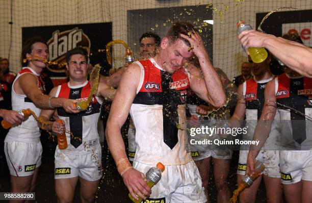 Darragh Joyce of the Saints is sprayed with drinks in the rooms after winning the round 15 AFL match between the Melbourne Demons and the St Kilda...