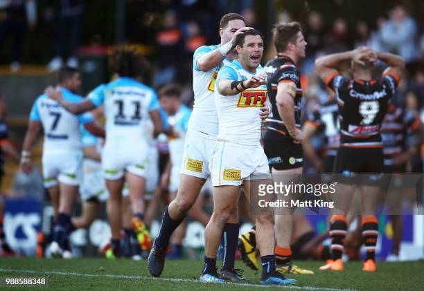 Brenko Lee and Michael Gordon of the Titans celebrate their final try during the round 16 NRL match between the Wests Tigers and the Gold Coast...
