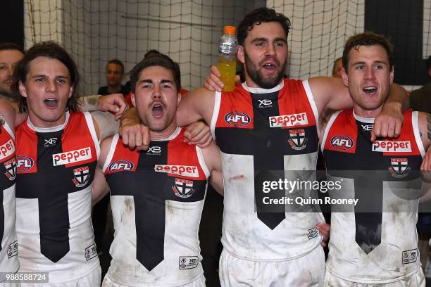 Hunter Clark, Jade Gresham, Paddy McCartin and Tim Membrey of the Saints sing the song in the rooms after winning the round 15 AFL match between the...