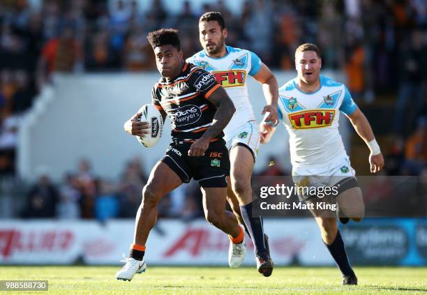 Kevin Naiqama of the Tigers makes a break during the round 16 NRL match between the Wests Tigers and the Gold Coast Titans at Leichhardt Oval on July...