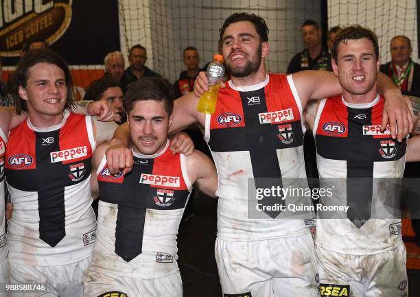 Hunter Clark, Jade Gresham, Paddy McCartin and Tim Membrey of the Saints sing the song in the rooms after winning the round 15 AFL match between the...