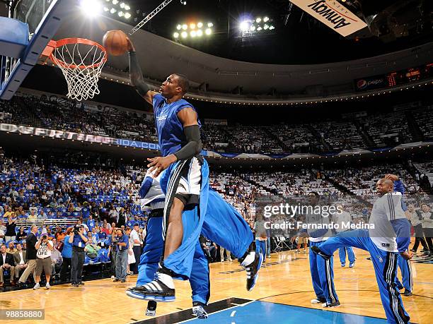 Dwight Howard of the Orlando Magic dunks as Mickael Pietrus and Anthony Johnson react during the teams pregame ritual before play against the Atlanta...
