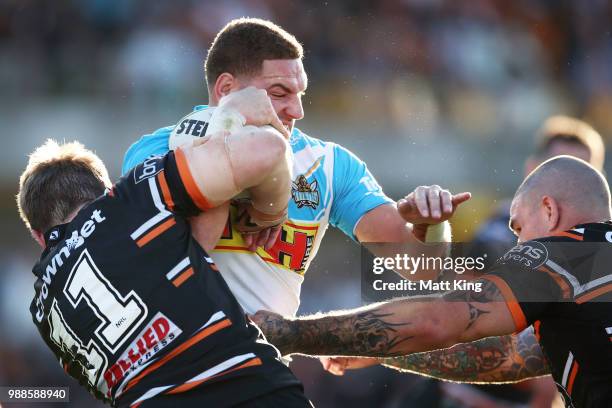 Brenko Lee of the Titans is tackled during the round 16 NRL match between the Wests Tigers and the Gold Coast Titans at Leichhardt Oval on July 1,...