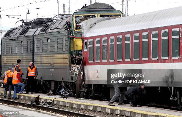 Investigators examine the scene where freight locomotive smashed a passanger car in the train station in the eastern Slovakia's town of Spisska Nova...