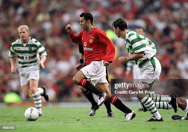 Ryan Giggs of Man Utd goes through the Celtic defence during the Manchester United v Celtic Ryan Giggs Testimonial match at Old Trafford, Manchester....