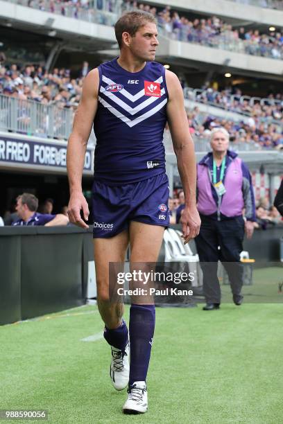 Aaron Sandilands of the Dockers heads to the rooms before the first bounce after receiving treatment for his right calf during the round 15 AFL match...