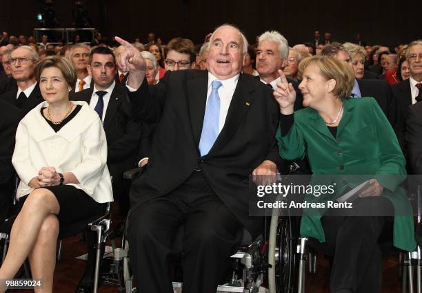 Maike Kohl-Richter, former German Chancellor Helmut Kohl and German Chancellor Angela Merkel smile during an official birthday reception to former...