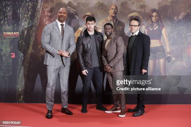 The actors Dwayne Johnson , Nick Jonas and Kevin Hart and the director Jake Kasdan attend the German premiere of the movie 'Jumanji: Welcome to the...