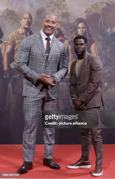 The actors Dwayne Johnson and Kevin Hart and the director Jake Kasdan attend the German premiere of the movie 'Jumanji: Welcome to the Jungle' in...