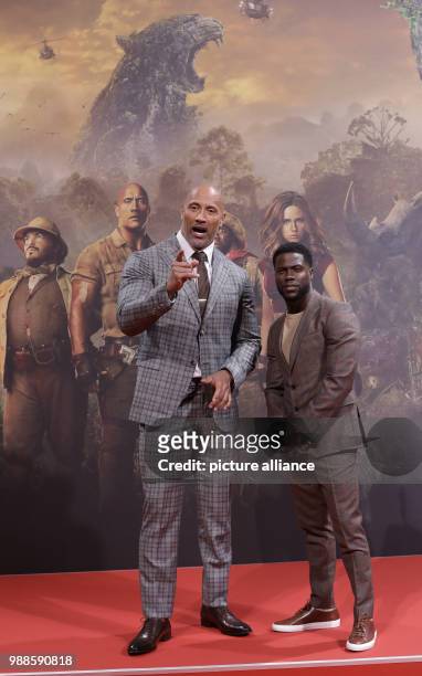 The actors Dwayne Johnson and Kevin Hart and the director Jake Kasdan attend the German premiere of the movie 'Jumanji: Welcome to the Jungle' in...