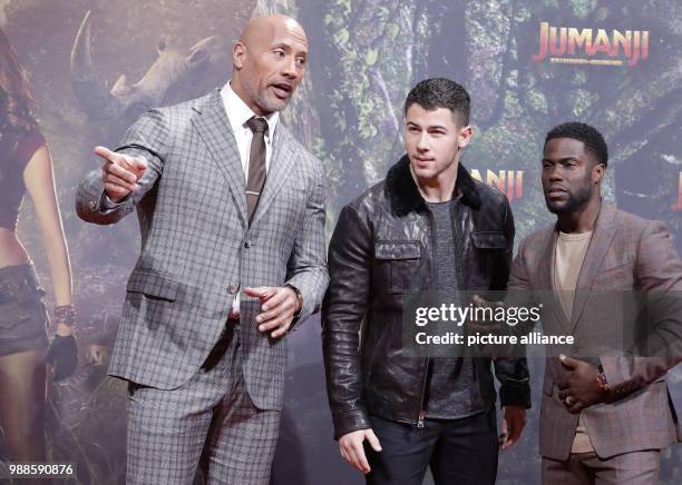 The actors Dwayne Johnson , Nick Jonas and Kevin Hart and the director Jake Kasdan attend the German premiere of the movie 'Jumanji: Welcome to the...