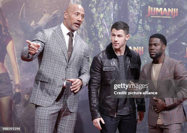 Actors Dwayne Johnson , Nick Jonas and Kevin Hart attend the German premiere of 2017 American action adventure film 'Jumanji: Welcome to the Jungle'...