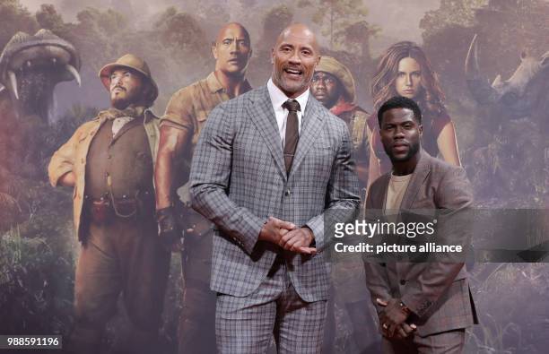 Actors Dwayne Johnson and Kevin Hart attend the German premiere of 2017 American action adventure film 'Jumanji: Welcome to the Jungle' in Berlin,...