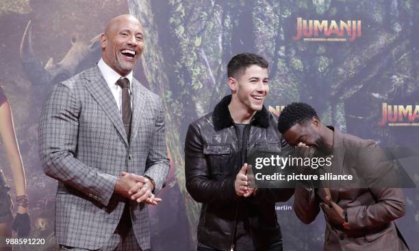 Actors Dwayne Johnson , Nick Jonas and Kevin Hart attend the German premiere of 2017 American action adventure film 'Jumanji: Welcome to the Jungle'...