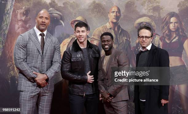 Actors Dwayne Johnson , Nick Jonas, Kevin Hart and director Jake Kasdan attend the German premiere of 2017 American action adventure film 'Jumanji:...