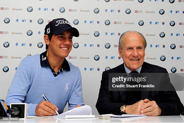 Matteo Manassero of Italy signs documents as an Italian team member with Franco Chimenti, president of the Italian golf federation during a press...
