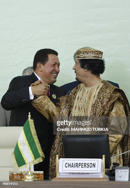 Libyan leader Moamer Kadhafi welcomes his Venezuelan counterpart Hugo Chavez during a special African Union summit in Tripoli on August 31 on the eve...