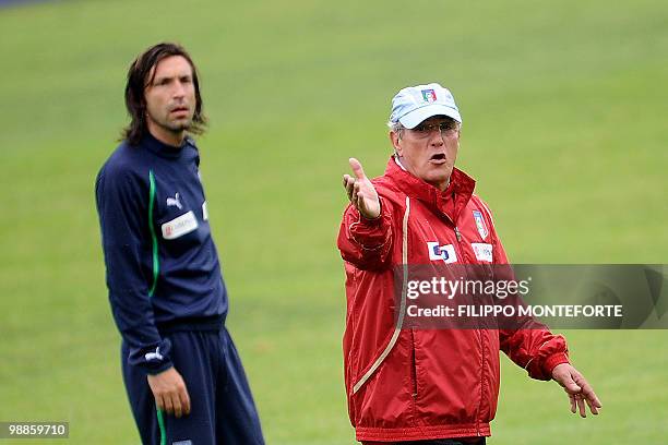 Italy's coach Marcello Lippi gestures infront of midfielder Andrea Pirlo during a training session of the italian national team on the outskirts of...