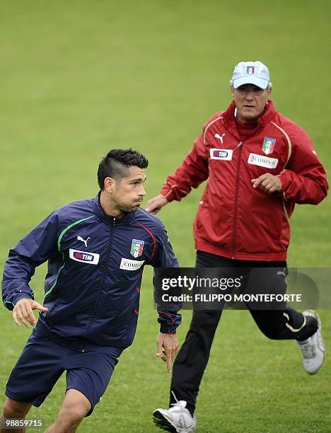 Italy's coach Marcello Lippi runs after forward Marco Borriello during a training session of the italian national team on the outskirts of Rome on...